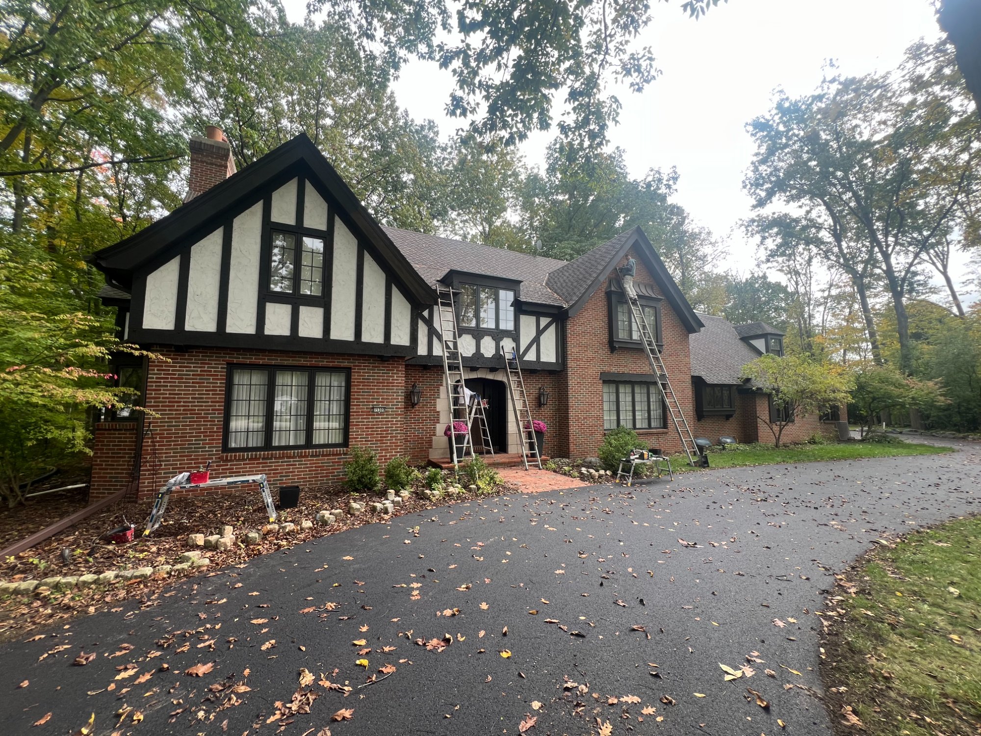 Spacious bathroom with fresh white walls, natural wood vanity, tile floor, and walk-in shower