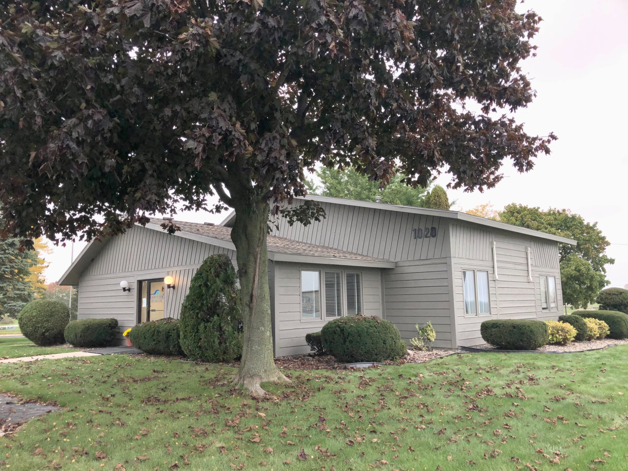 Commercial office building after fresh sage gray exterior paint, front view