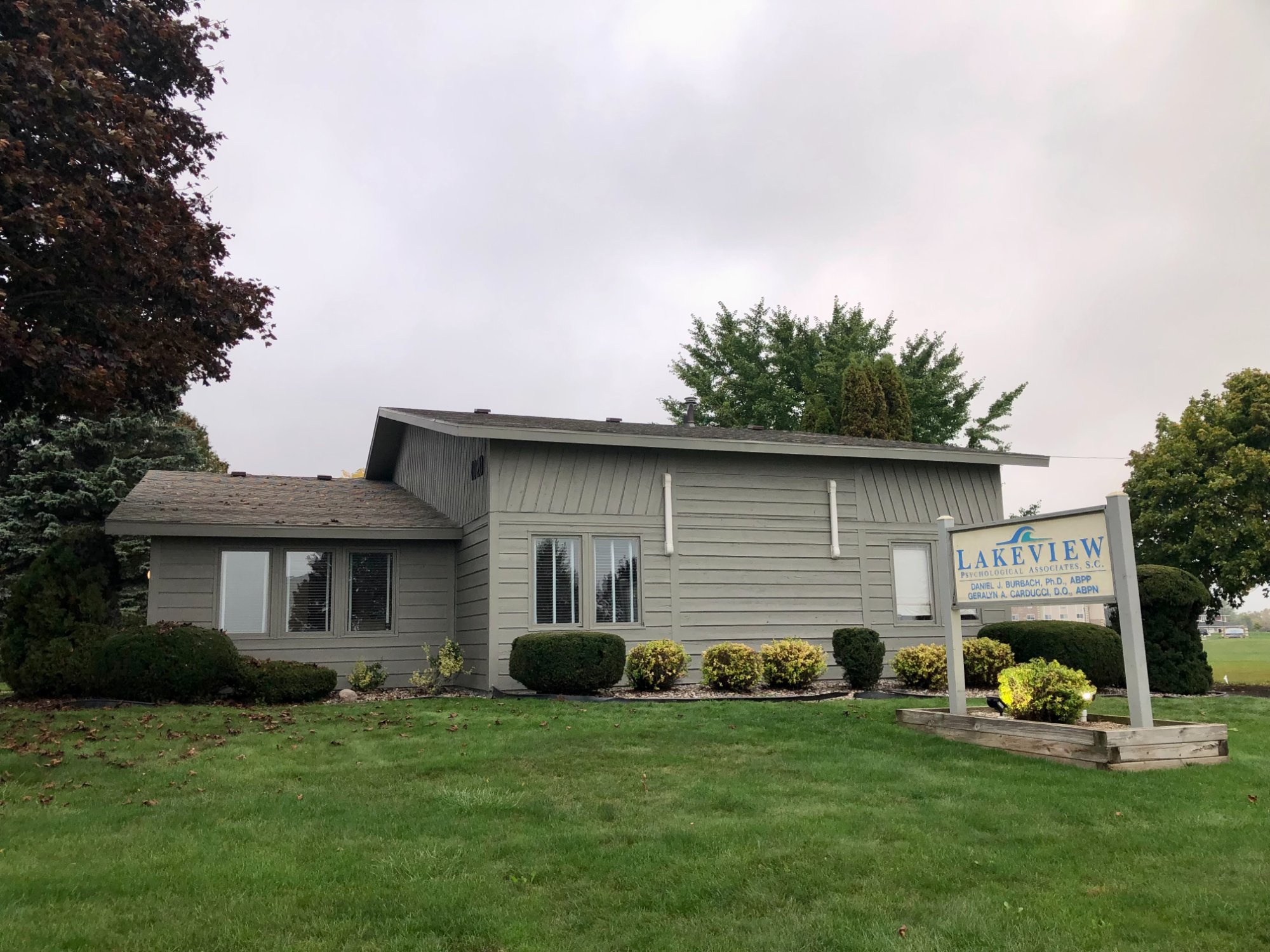 Commercial office building after painting, side view with business sign