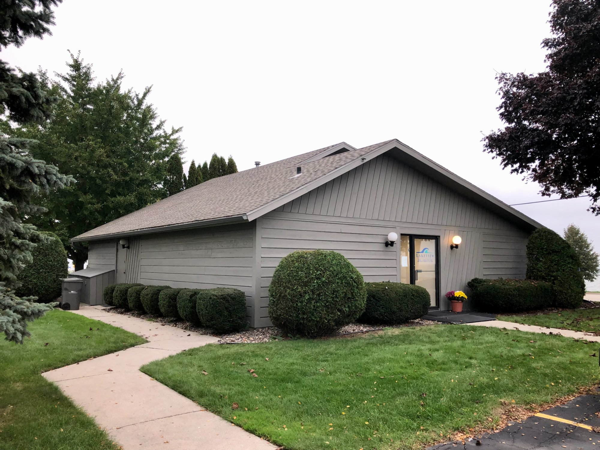Commercial office building after fresh paint, front entry with walkway