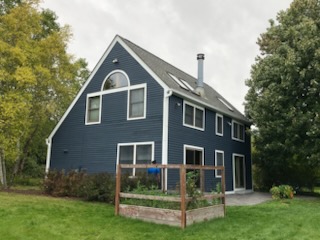 Same A-frame house after professional exterior painting in navy blue by Wisconsin's Best Painters