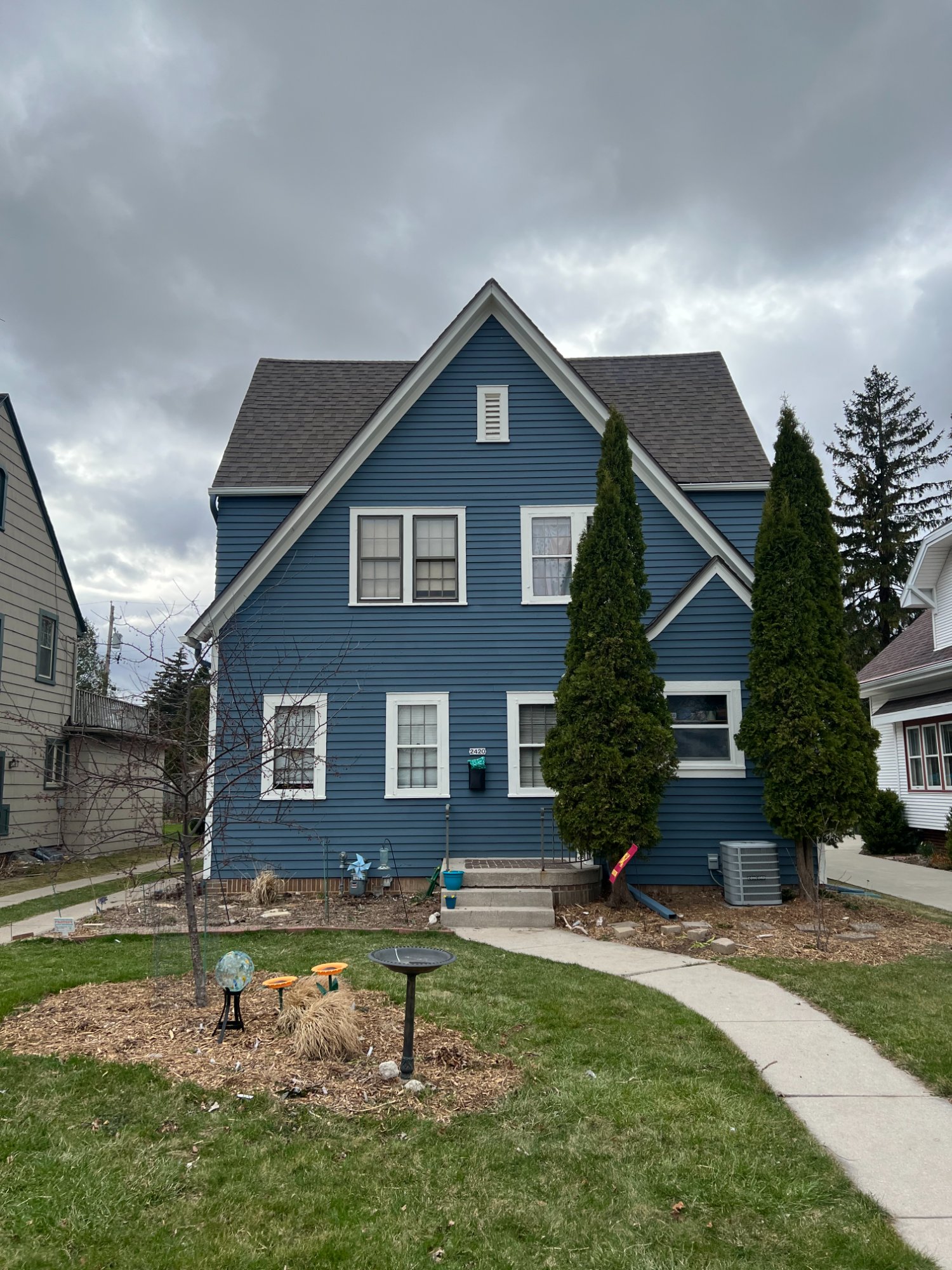 Two-story blue clapboard house with white trim and front walkway